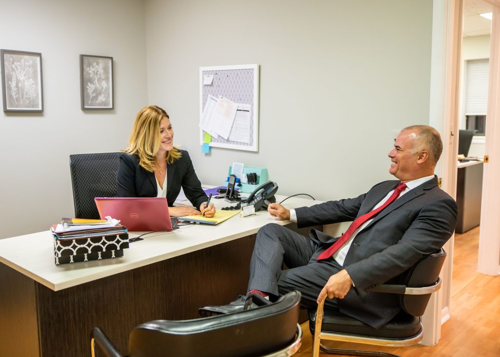 Ken Harrell and Leigh Raffauf smiling and talking