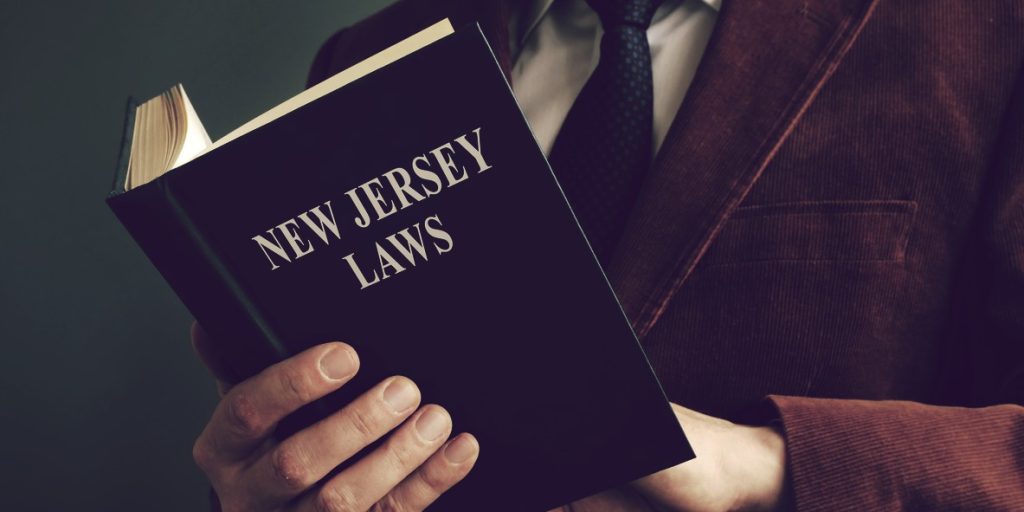 Open New Jersey laws book in a hand