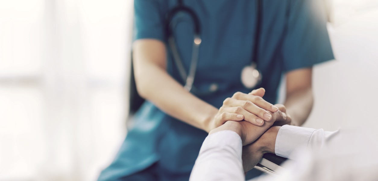 Doctor holding a patience's hand